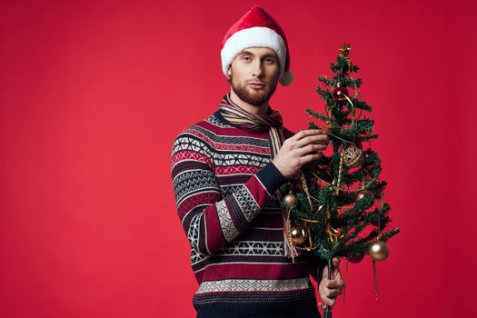 emotional man in a santa hat Christmas decorations holiday New Year isolated background. High quality photo