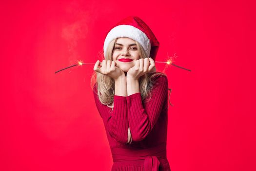 pretty woman in santa hat holiday christmas emotion sparklers. High quality photo