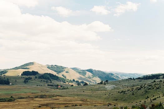 Green hills against a cloudy sky. High quality photo