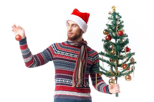 Cheerful man in a santa hat Christmas decorations holiday New Year studio posing. High quality photo