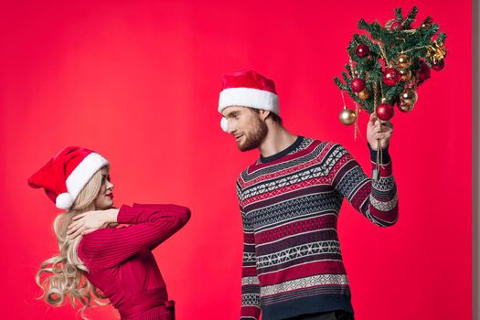cheerful young couple christmas holiday red background decoration. High quality photo