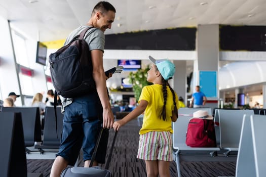 Young father with daughter at the airport.