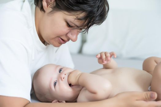 Portrait of a mother with her 6 months old baby, top view point.