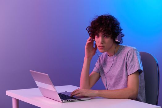 man in headphones in front of laptop entertainment Lifestyle technology. High quality photo