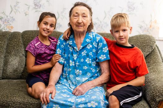 Grandmother with grandchild. Old woman with children.