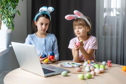 little girls for easter paint eggs, record lessons on web camera with laptop.