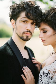 Bride put her hands on the groom chest. Portrait. High quality photo