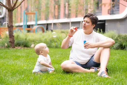 Mother and baby in park portrait.