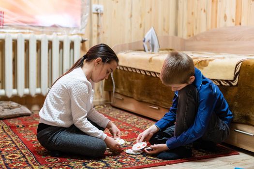 Children playing with blocks on the floor - focus on the boy's face.