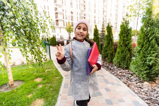 School club. Modern education. Private schooling. Teen with backpack. Stylish smiling schoolgirl. Girl little fashionable schoolgirl carry backpack school building background. Schoolgirl daily life