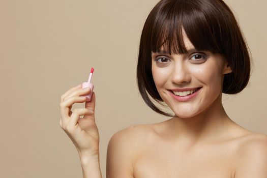 woman lipstick cosmetics attractive look posing beige background. High quality photo