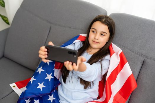 Back to online school education. Difficult to speak English. Kid doing homework on computer. Student studying on laptop over American flag. Tutor teach distantly