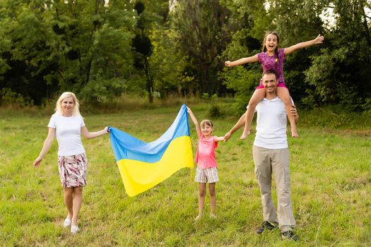 Ukraine's Independence Flag Day. Constitution day. family with the flag of ukraine in field. 24 August. Patriotic holiday