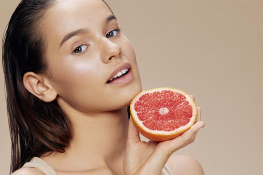 young woman grapefruit near face clean skin care health isolated background. High quality photo