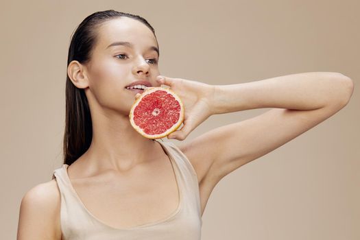 portrait woman grapefruit near face clean skin care health isolated background. High quality photo