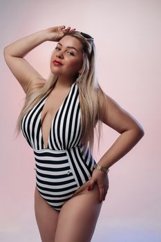 beautiful woman with long blonde hair in black and white swimsuit