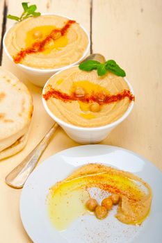 traditional chickpeas Hummus with pita bread and paprika on top 