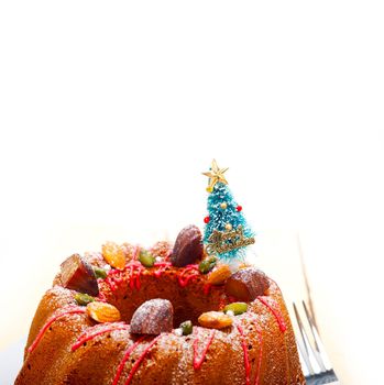 Christmas cake donut with tree as festive decoration on top over white background