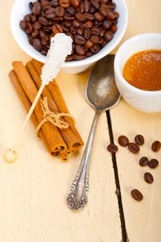 espresso coffee  over white wood rustic table  with sugar and spice