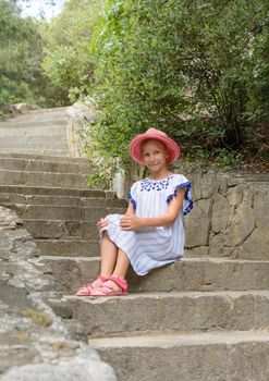 Teen Girl 9 years Sitting On The Stone Stairs in Park