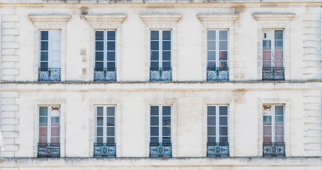 Architectural building with windows and railings o Rochefort in France