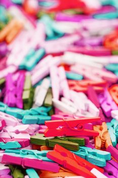 Colorful Wooden clothespins close-up as texture and background. Decorative clothespins for creativity and needlework.