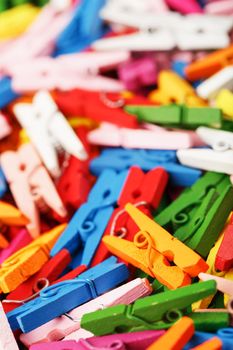 Colorful Wooden clothespins close-up as texture and background. Decorative clothespins for creativity and needlework.