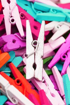 Colorful Wooden clothespins close-up as texture and background. Decorative clothespins for creativity and needlework.