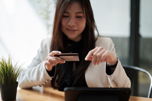 Young woman holding credit card and using smart phone for online shopping. Online payment shopping concept. copyspace banner.