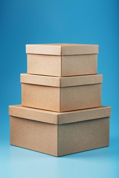 Postal cardboard boxes on a blue background close-up. Free space for text and delivery ads.
