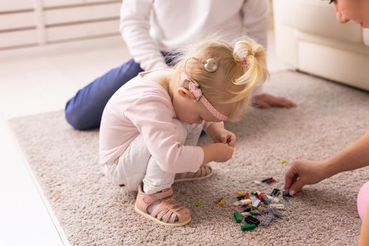 Kid with cochlear implants playing with toys at home. Deafness and medical technology