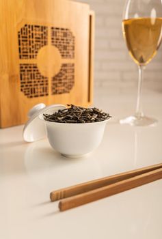 tea table with appliances and wine glasses, in which large-leaf tea is brewed