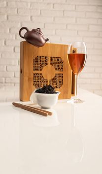 tea table with appliances and wine glasses, in which large-leaf tea is brewed