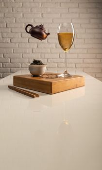 tea table with appliances and wine glasses, in which large-leaf tea is brewed