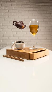 tea table with appliances and wine glasses, in which large-leaf tea is brewed