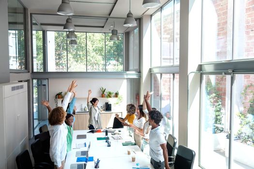 Group of multiracial colleagues celebrate company's victory with high five. Copy space. Business concept.