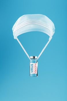 Ampoule and syringe with the vaccine against the Virus against diseases on a blue background. Free space on the ampoule label for text.