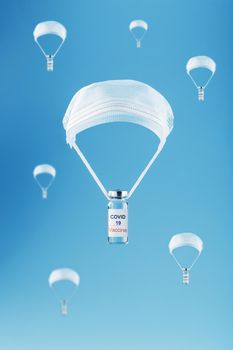 Ampoules with a vaccine against the coronavirus infection COVID-19 were dropped by parachute from a protective mask on a blue background. The concept of assistance in the mass vaccination of the population from the virus. Steamer flight, fast air delivery.