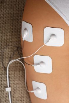 Electrode Stimulating massage of the buttocks and legs at home. Medical procedure for muscle tone and beauty
