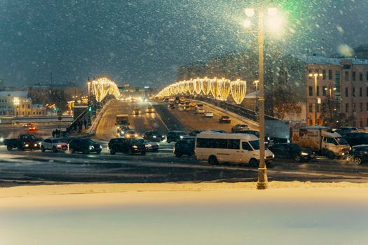 01.22.2022 Moscow, Russia. road traffic on the big moskvoretsky bridge at night in snowfall