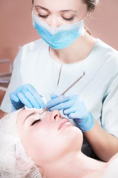 Close-up Professional face cleaning. Mechanical facial cleansing procedure. Peeling of the skin of the face