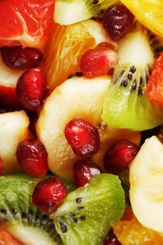 Pieces of raznfh fruit close-up in full screen, Fruit salad. Slices of fresh and healthy fruits for a healthy diet.