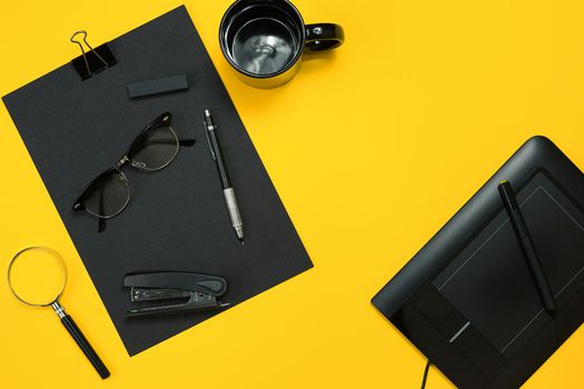 Workplace with office items and business elements on a yellow background. Concept for branding. Top view. Copy space. Still life