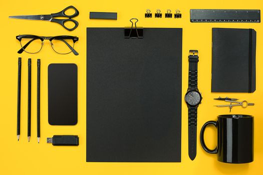 Workplace with office items and business elements on a yellow background. Concept for branding. Top view. Copy space. Still life
