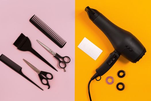 Hairdresser tools on pink and orange background with copy space. Top view. Still life. Mock-up. Flat lay