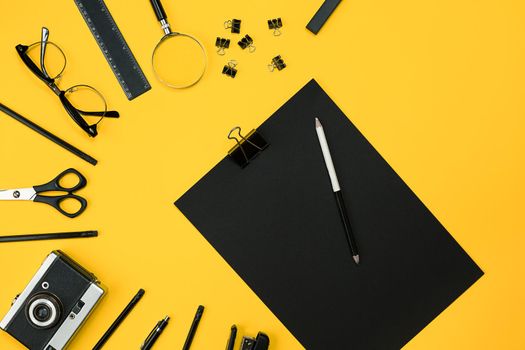 Workplace with office items and business elements on a yellow background. Concept for branding. Top view. Copy space. Still life