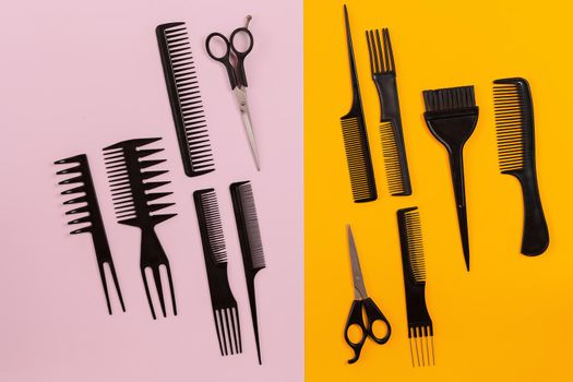 Hairdresser tools on pink and orange background with copy space. Top view. Still life. Mock-up. Flat lay