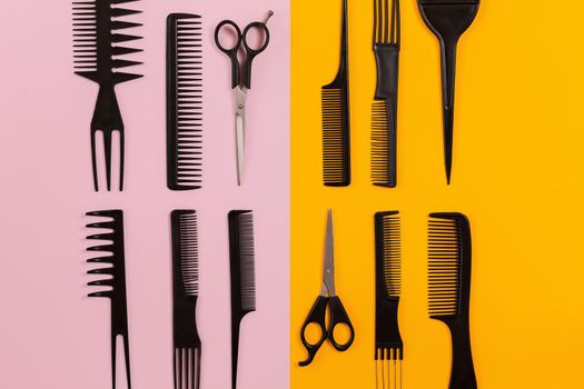 Hairdresser tools on pink and orange background with copy space. Top view. Still life. Mock-up. Flat lay