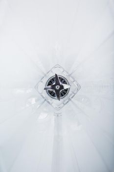 Close-up of a blender glass shot from the inside with sharp stainless steel blades in the center. Inside view, full screen. Conceptual perspective