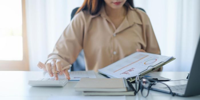 Business woman working to analyze technical price graph and indicator. account or saving money or insurance concept